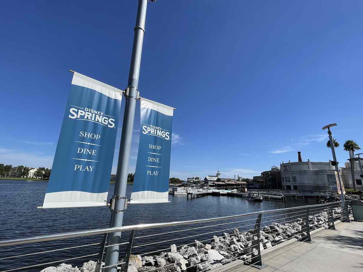 disney springs banner sign with view of water and walkway in orlando florida
