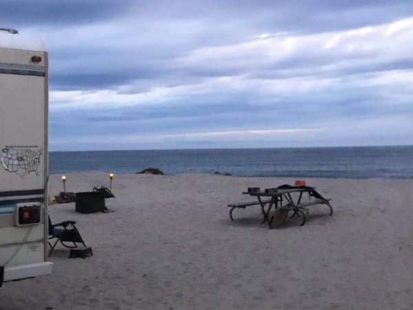 evening firepit at jalama beach with solar torches in the sand